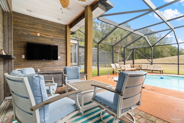 view of patio / terrace featuring glass enclosure, an outdoor pool, outdoor lounge area, and ceiling fan