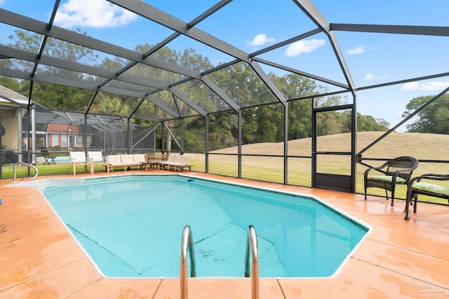 pool featuring glass enclosure, a yard, and a patio