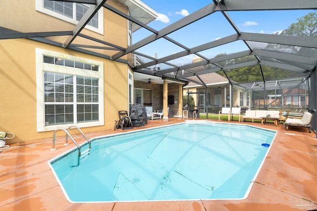 outdoor pool with a lanai and a patio area