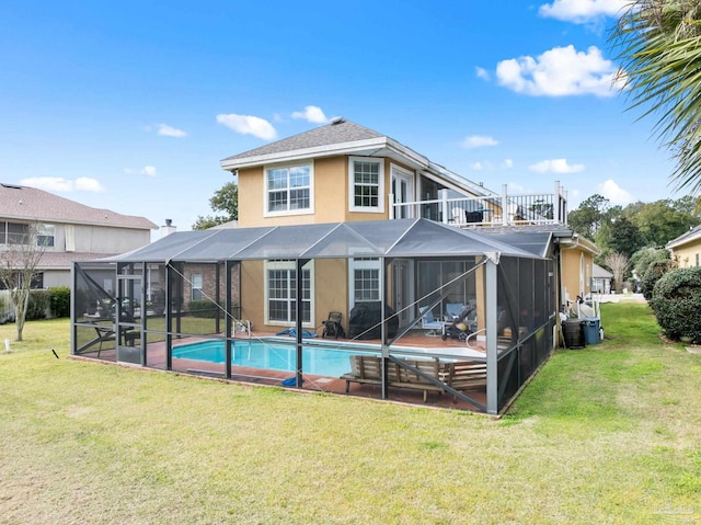 rear view of house featuring a shingled roof, an outdoor pool, a lawn, glass enclosure, and stucco siding