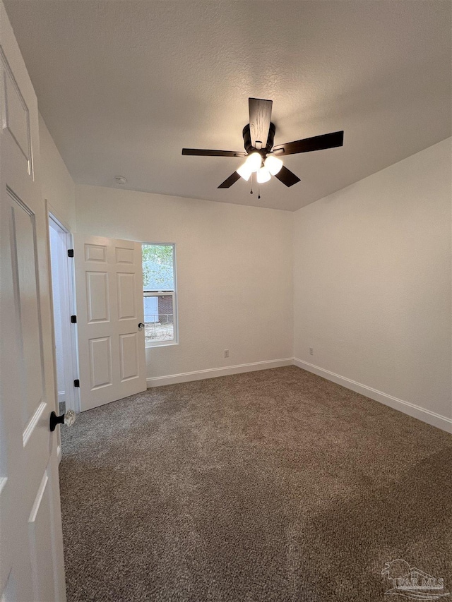 carpeted spare room with ceiling fan