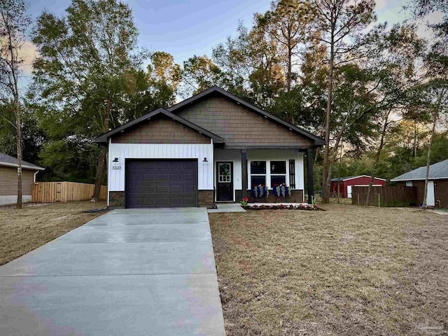 view of front of home featuring covered porch and a garage