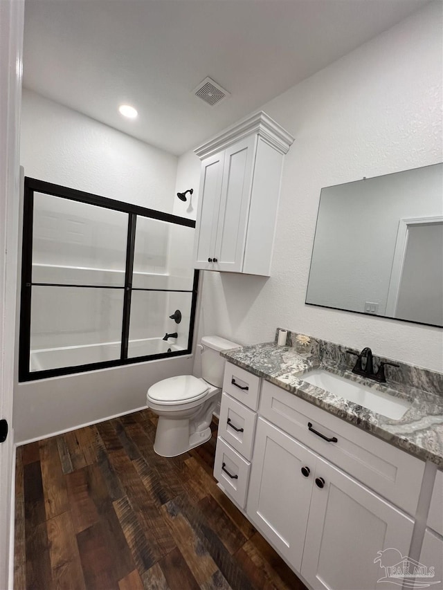 full bathroom with toilet, vanity, enclosed tub / shower combo, and hardwood / wood-style flooring