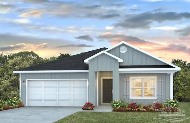 view of front of property with a lawn and a garage