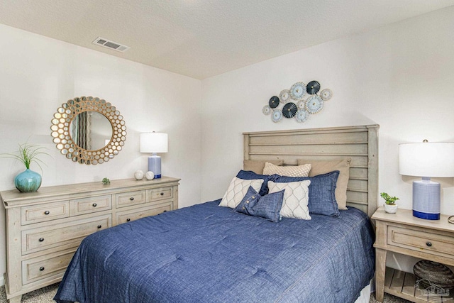 carpeted bedroom featuring a textured ceiling