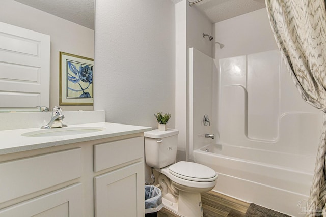 full bathroom with shower / bath combination with curtain, a textured ceiling, hardwood / wood-style floors, vanity, and toilet