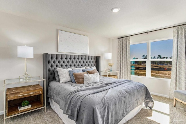 bedroom featuring a textured ceiling and carpet