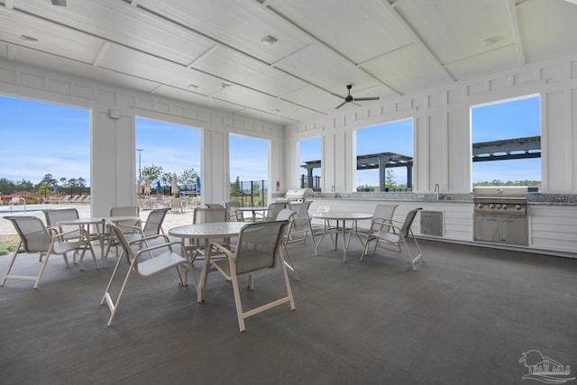 view of patio with ceiling fan, area for grilling, sink, and exterior kitchen