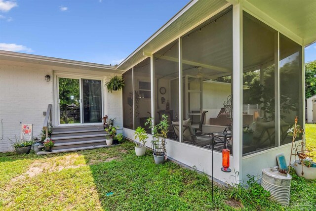 2543 Bayview Way, Pensacola, FL 32503 - view of exterior entry with brick siding and a lawn