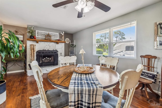 2543 Bayview Way, Pensacola, FL 32503 - dining area with a ceiling fan, wood finished floors, a fireplace, and baseboards