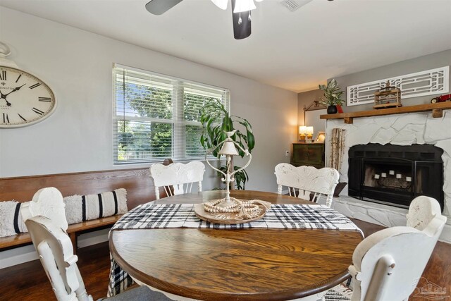 2543 Bayview Way, Pensacola, FL 32503 - dining space featuring a ceiling fan, wood finished floors, and a fireplace with raised hearth
