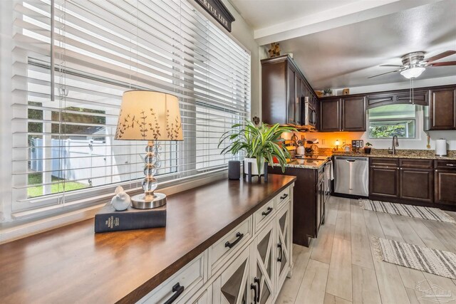 2543 Bayview Way, Pensacola, FL 32503 - kitchen featuring stainless steel dishwasher, dark brown cabinets, light wood-style floors, ceiling fan, and dark stone counters