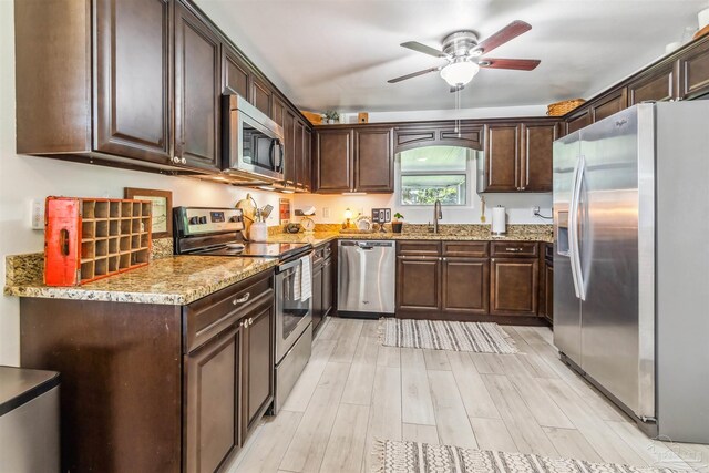 2543 Bayview Way, Pensacola, FL 32503 - kitchen with stainless steel appliances, a sink, ceiling fan, and dark brown cabinets