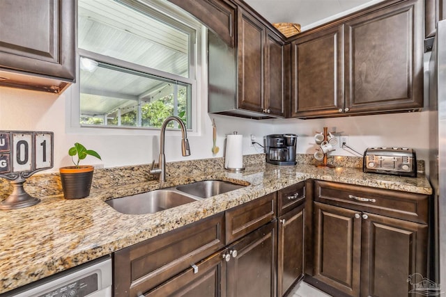 2543 Bayview Way, Pensacola, FL 32503 - kitchen featuring a sink, dark brown cabinets, dishwashing machine, and light stone countertops