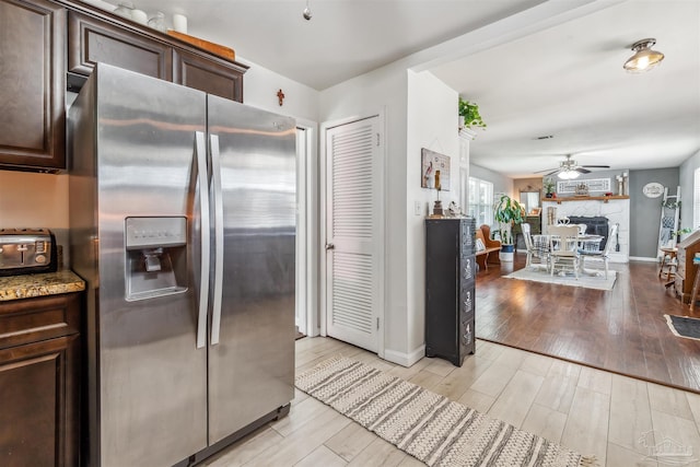 2543 Bayview Way, Pensacola, FL 32503 - kitchen with stainless steel fridge with ice dispenser, dark brown cabinetry, light wood-type flooring, ceiling fan, and baseboards