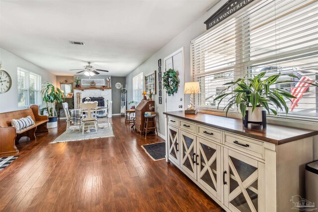 2543 Bayview Way, Pensacola, FL 32503 - dining space featuring dark wood finished floors, a ceiling fan, a fireplace, and baseboards
