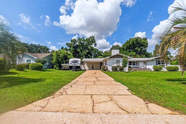 2543 Bayview Way, Pensacola, FL 32503 - view of front of house featuring driveway, a front lawn, a chimney, and a carport