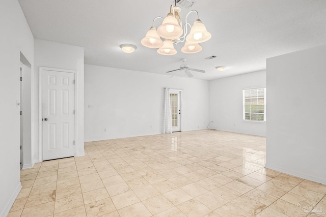 spare room featuring ceiling fan with notable chandelier