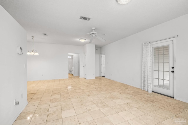 unfurnished room with ceiling fan with notable chandelier