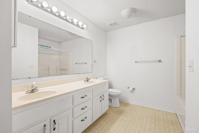 full bathroom with vanity, toilet, a textured ceiling, and shower / washtub combination