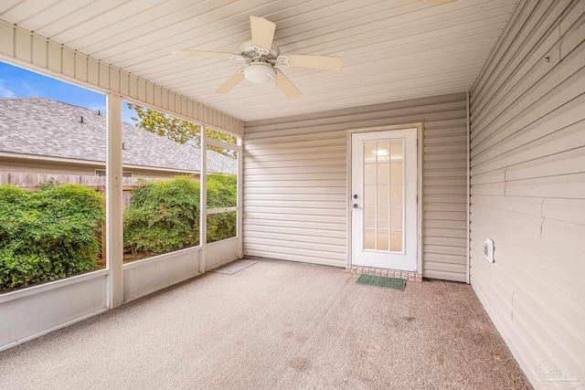 unfurnished sunroom with ceiling fan