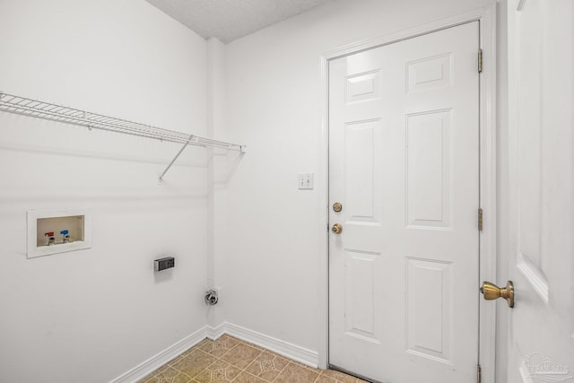 laundry area with washer hookup and a textured ceiling