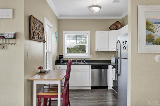 13555 Perdido Key Dr Unit A17U, Pensacola, FL 32507 - kitchen with stainless steel appliances, dark countertops, ornamental molding, white cabinetry, and dark wood-style floors