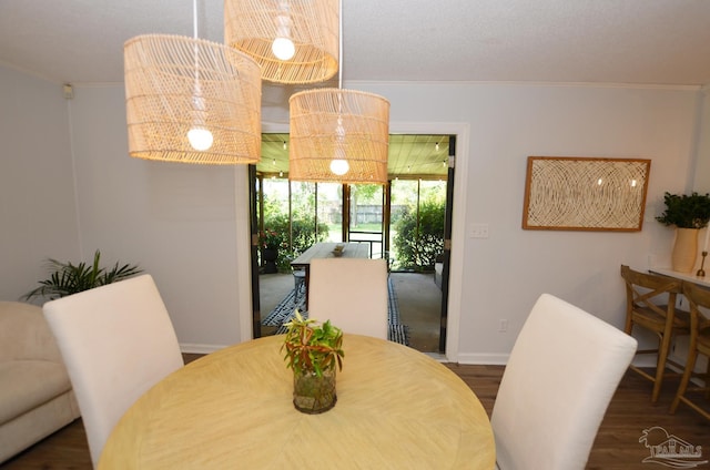 dining area with crown molding and dark hardwood / wood-style flooring