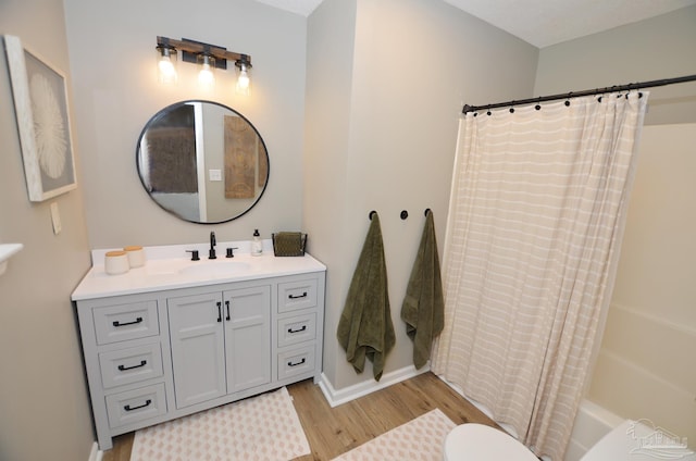 bathroom with vanity, wood-type flooring, and shower / bath combo with shower curtain