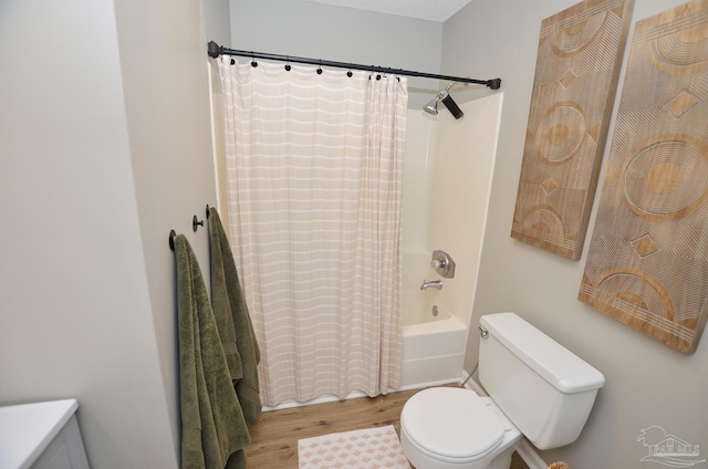 bathroom with hardwood / wood-style floors, shower / bath combo, and toilet