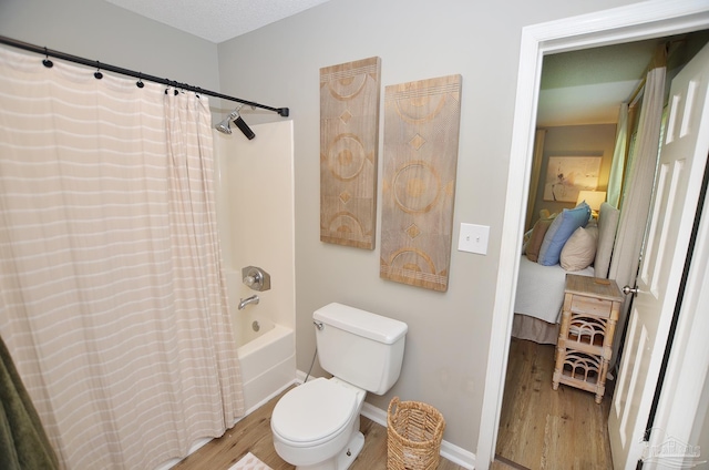 bathroom featuring toilet, shower / tub combo with curtain, and hardwood / wood-style flooring