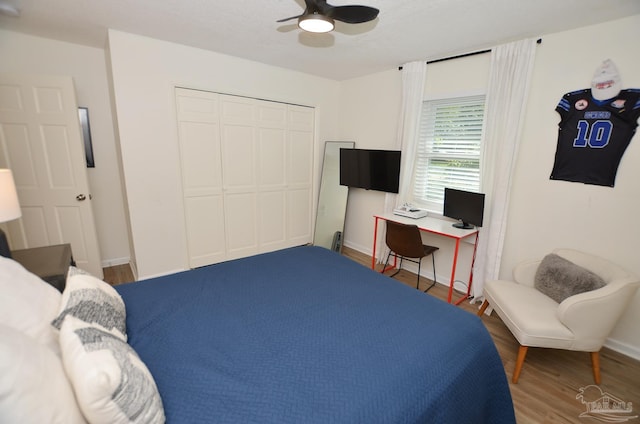 bedroom with wood-type flooring, a closet, and ceiling fan