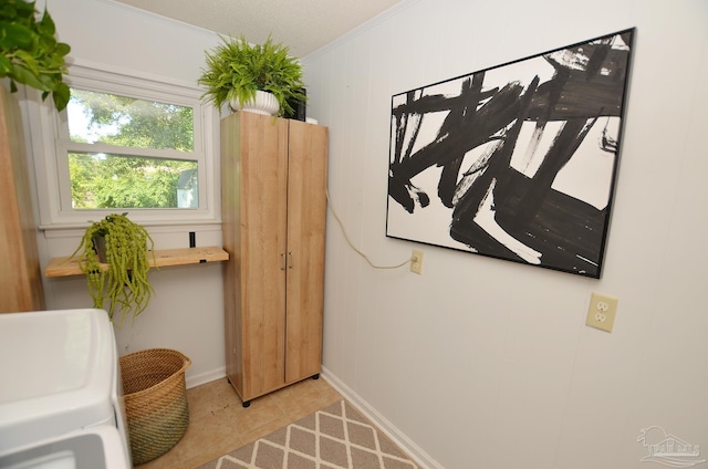 interior space featuring washer / clothes dryer and ornamental molding