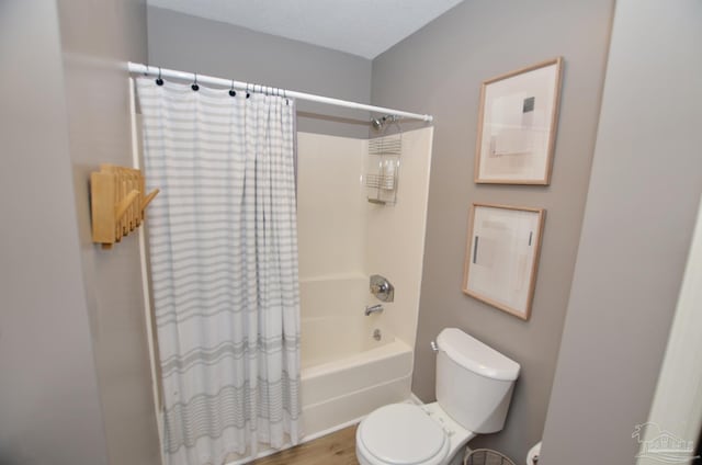 bathroom with wood-type flooring, toilet, and shower / bathtub combination with curtain