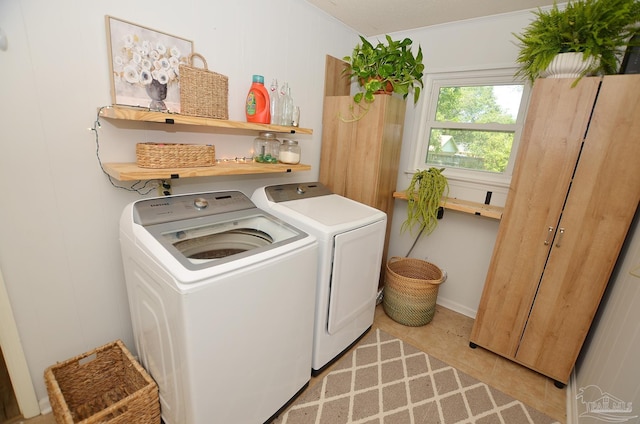 laundry room featuring separate washer and dryer and crown molding