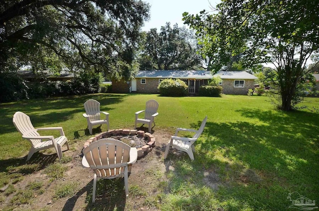 view of yard with an outdoor fire pit