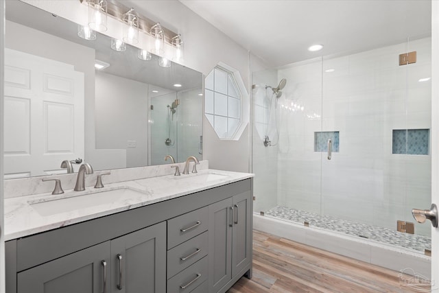 bathroom featuring hardwood / wood-style floors, vanity, and an enclosed shower