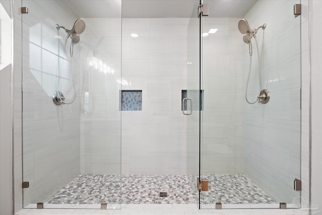 bathroom featuring a shower with shower door