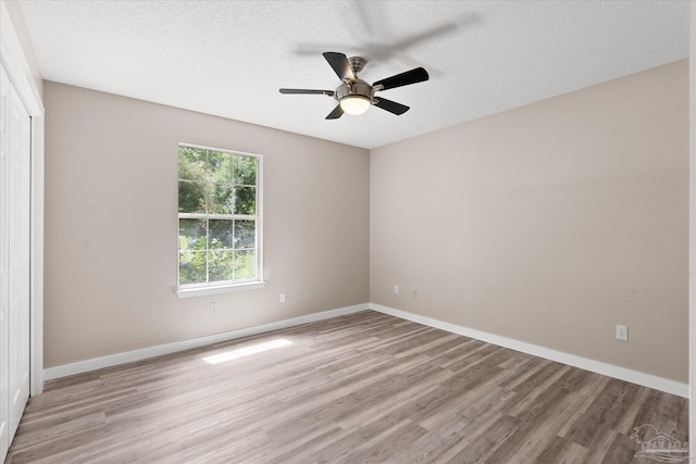 unfurnished room featuring ceiling fan, a textured ceiling, and light hardwood / wood-style flooring