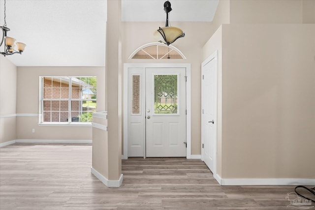 entryway with a chandelier and light hardwood / wood-style floors