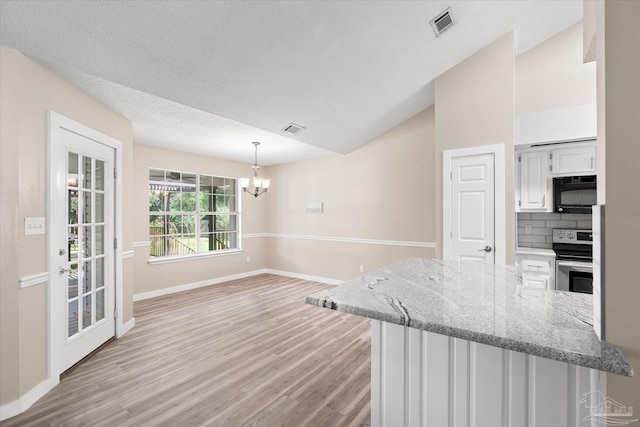 kitchen with white cabinetry, tasteful backsplash, lofted ceiling, decorative light fixtures, and stainless steel electric range