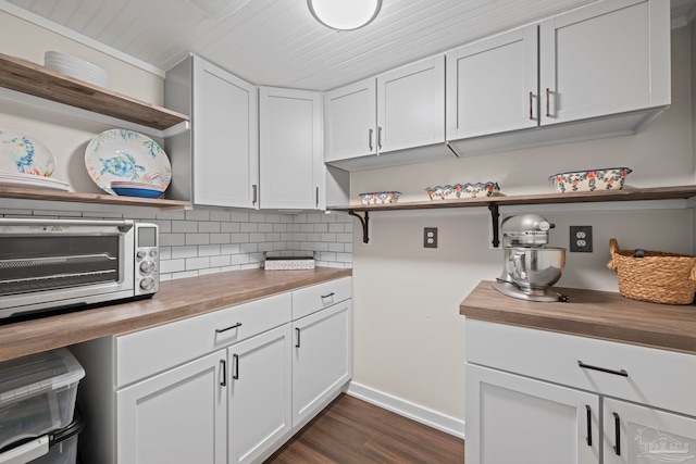 kitchen with tasteful backsplash, butcher block counters, white cabinets, and open shelves