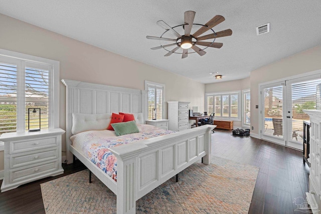 bedroom featuring a textured ceiling, a ceiling fan, visible vents, access to exterior, and dark wood finished floors