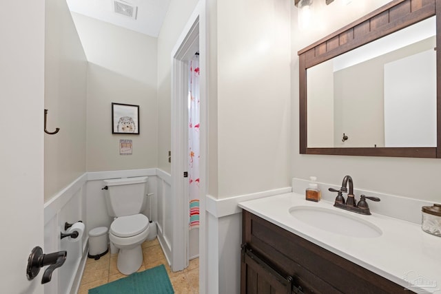 bathroom featuring tile patterned flooring, visible vents, vanity, and toilet