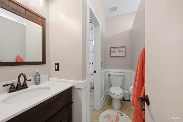 bathroom featuring tile patterned flooring, visible vents, vanity, and toilet