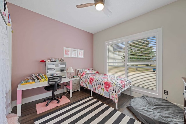 bedroom featuring a ceiling fan, baseboards, and wood finished floors