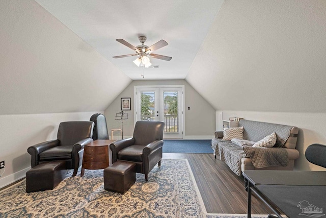 sitting room with ceiling fan, wood finished floors, visible vents, baseboards, and vaulted ceiling