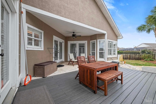 wooden deck featuring outdoor dining area, a ceiling fan, and french doors