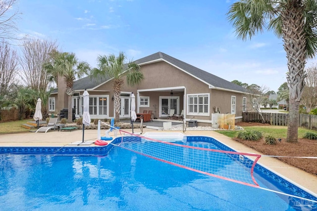 view of pool featuring ceiling fan, fence, french doors, a fenced in pool, and a patio area