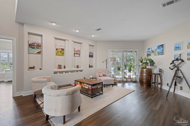 interior space featuring dark wood-style floors, visible vents, and baseboards